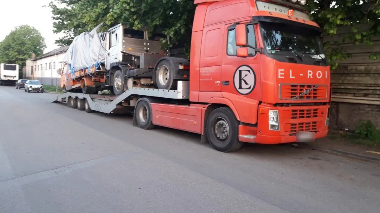 Car transporter loaded with two trucks for export