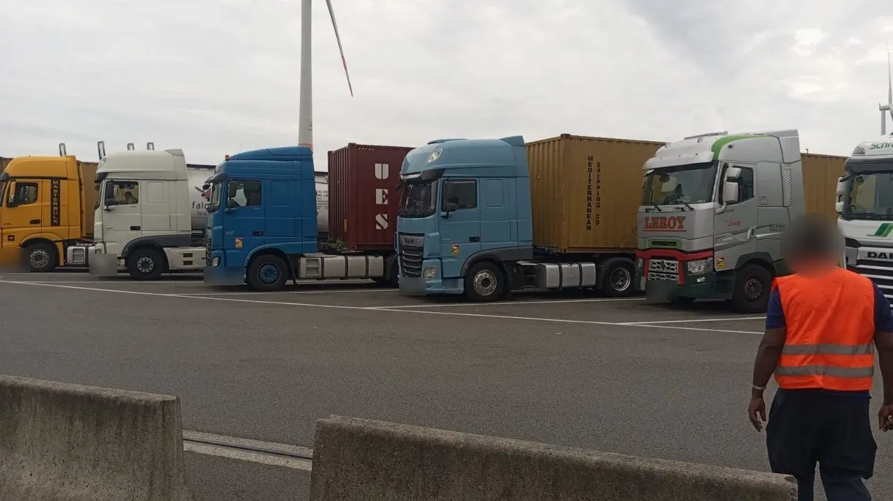 Trucks lined up with containers at the port, ready for loading